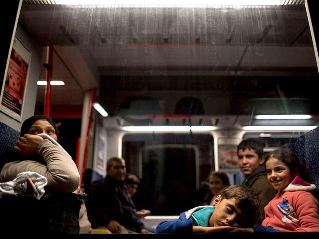 Migrants rest on a train to Vienna as they leave from Nickelsdorf. Thousands of migrants streamed into Austria on Saturday, desperate to travel on to Germany after days of ugly standoffs with authorities in Budapest's train station that made headlines worldwide. (AFP Photo)
