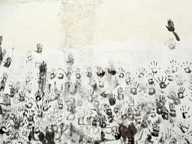 The handprints of revellers covered in grease are pictured onto a wall during the annual Cascamorras festival. (Reuters Photo)
