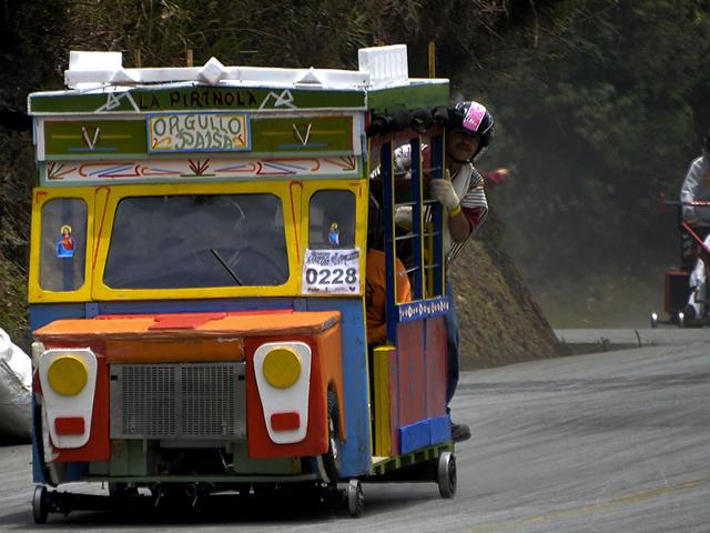 Participants descend a hill in a homemade bus-shaped car on September 6, 2015. (AFP)