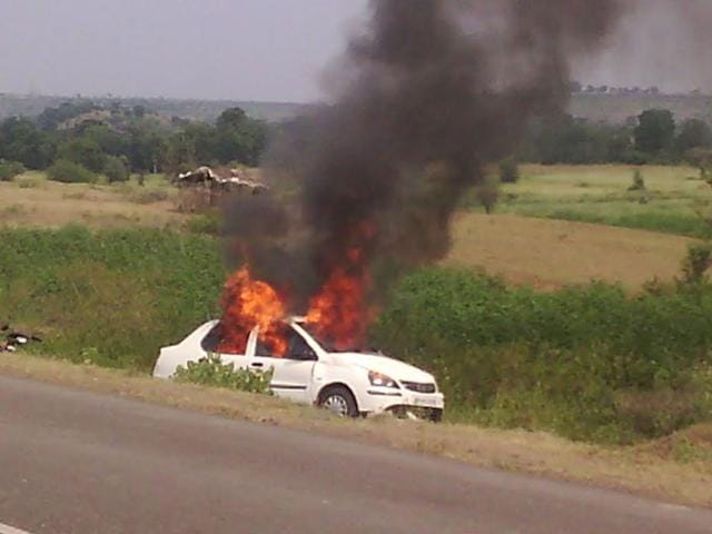 The car torched by the villagers after the accident in Barwani. (HT photo)