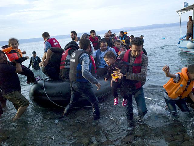 Refugees and migrants arrive on a dinghy on the Greek island of Lesbos. (Reuters Photo) Refugees and migrants arrive on a dinghy on the Greek island of Lesbos. (Reuters Photo)