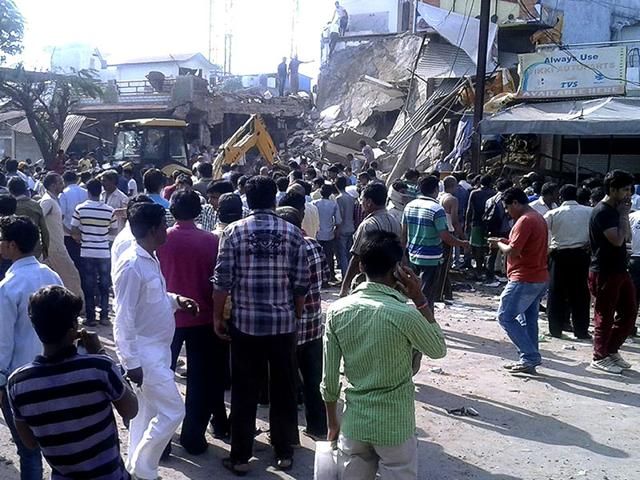 Locals crowd around the site of an explosion in which at least 90 people were killed after a gelatin rod in a building caught fire and exploded in Madhya Pradesh's Jhabua district. (HT Photo) Locals crowd around the site of an explosion in which at least 90 people were killed after a gelatin rod in a building caught fire and exploded in Madhya Pradesh's Jhabua district. (HT Photo)