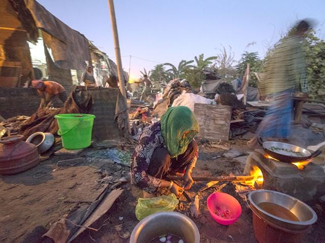 A Rohingya Muslim woman cooks in a semi-dismantled house, after they were forced to give up a section of their refugee camp area by local authorities, at a refugee camp in Kalandi Kunj area of New Delhi, India, on Thursday, September 10, 2015. (Photo by Gurinder Osan/ Hindustan Times) A Rohingya Muslim woman cooks in a semi-dismantled house, after they were forced to give up a section of their refugee camp area by local authorities, at a refugee camp in Kalandi Kunj area of New Delhi, India, on Thursday, September 10, 2015. (Photo by Gurinder Osan/ Hindustan Times)