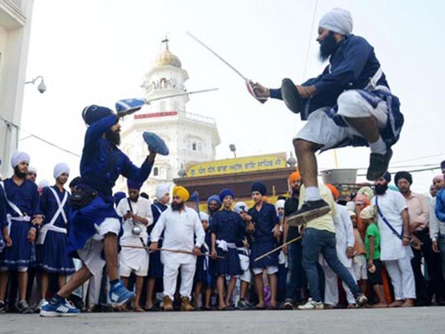 Sikh boys showing their skills during a 'nagar kirtan' outside the Golden Temple in Amritsar on Monday.(Sameer Sehgal/HT) Sikh boys showing their skills during a 'nagar kirtan' outside the Golden Temple in Amritsar on Monday.(Sameer Sehgal/HT)