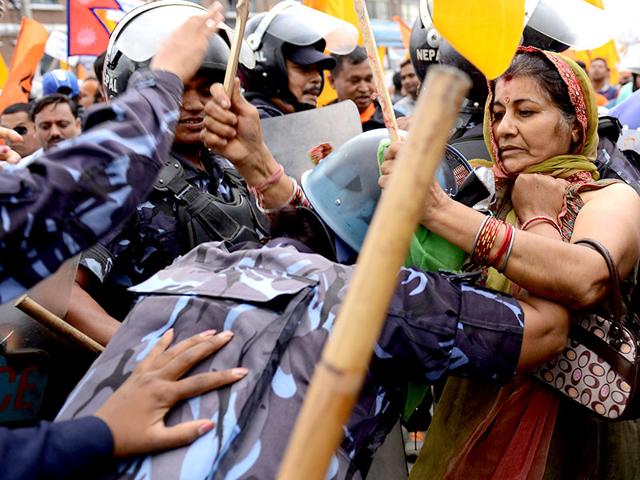 Nepalese police stop Hindu activists during a protest demanding Nepal be declared a Hindu state, in Kathmandu on Monday. (AFP Photo)