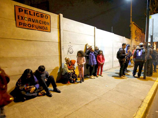 Residents stay on the street outside their houses after an earthquake hit Chile's central zone, in Santiago, Chile. (Reuters)