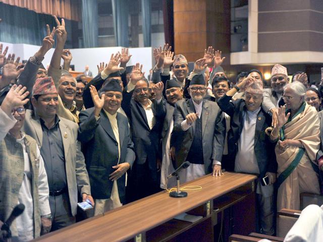 Nepal Prime Minister Sushil Koirala (3R),Unified Marxist Leninist chairman K P Oli (4R), Nepalese Unified Communist Party of Nepal (Maoist) chairman Pushpa Kamal Dahal, known better as Prachanda (4L) and other lawmakers wave while Nepal's parliament passes a new national constitution in Kathmandu. (AFP Photo) Nepal Prime Minister Sushil Koirala (3R),Unified Marxist Leninist chairman K P Oli (4R), Nepalese Unified Communist Party of Nepal (Maoist) chairman Pushpa Kamal Dahal, known better as Prachanda (4L) and other lawmakers wave while Nepal's parliament passes a new national constitution in Kathmandu. (AFP Photo)