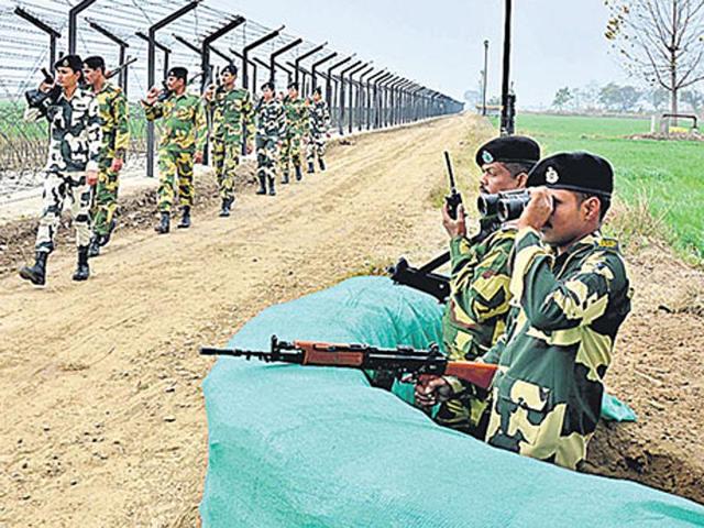 BSF jawans keep watch along the Indo-Pakistan International Border in Amritsar. BSF jawans keep watch along the Indo-Pakistan International Border in Amritsar.
