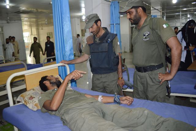 Pakistani commandos talk to their colleague injured during an attack, at a local hospital, Friday, Sept. 18, 2015 in Peshawar, Pakistan after the Taliban launched a brazen assault on a military base on the outskirts of the northwestern city, storming a mosque inside the sprawling compound and killing many worshippers during prayers. (AP)