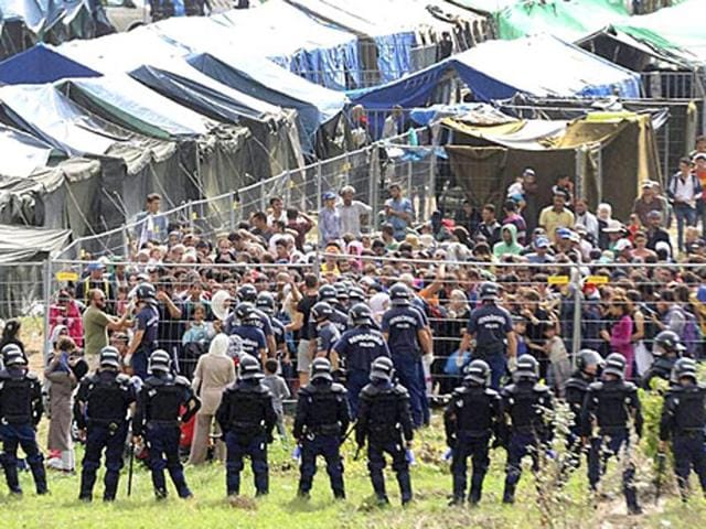 A standoff between migrants and Hungarian police officers at the migrant reception center in Roszke, Hungary, on September 4, 2015, after about 300 people broke out of the reception center. (ap) A standoff between migrants and Hungarian police officers at the migrant reception center in Roszke, Hungary, on September 4, 2015, after about 300 people broke out of the reception center. (ap)