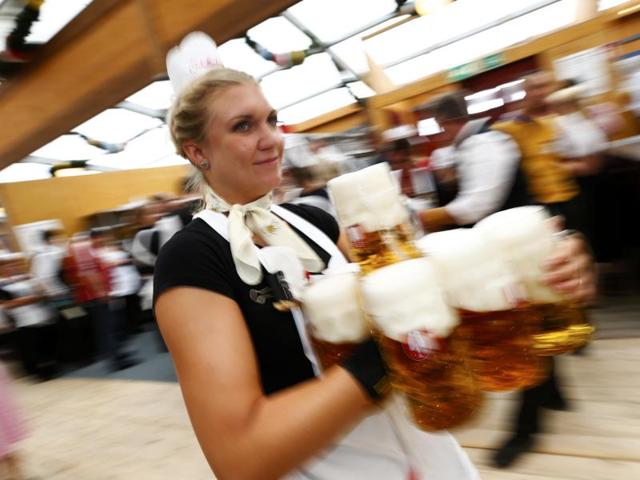 A waitress carries beer in a tent during the 182nd Oktoberfest in Munich. (REUTERS)