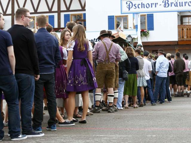 The long wait: Visitors stand in a queue ahead of the opening of the Oktoberfest on Saturday. (REUTERS)