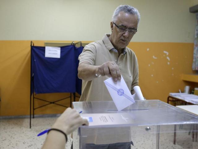 A man casts his vote at a polling station in Athens, Sunday. (AP) A man casts his vote at a polling station in Athens, Sunday. (AP)
