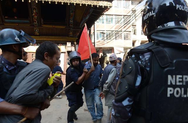 Nepalese police arrest a demonstrator during a general strike called by a hardline breakaway faction of former Maoist rebels (Communist Party of Nepal-Maoist) against the draft of the new constitution in Kathmandu on September 20,2015 even as the Himalayan nation adopted a new national constitution on Sunday. (AFP) Nepalese police arrest a demonstrator during a general strike called by a hardline breakaway faction of former Maoist rebels (Communist Party of Nepal-Maoist) against the draft of the new constitution in Kathmandu on September 20,2015 even as the Himalayan nation adopted a new national constitution on Sunday. (AFP)