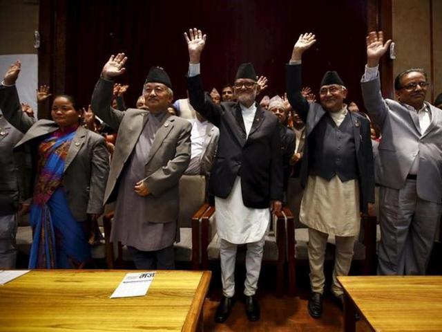 Nepal's Prime Minister Sushil Koirala (C), along with chairman of the Unified Communist Party of Nepal (Maoist) Pushpa Kamal Dahal, also known as Prachanda (R), chairman of the Communist Party of Nepal (Unified Marxist-Leninist) (CPN-UML) Khadga Prashad Oli, also known as KP Oli (2nd R), and Nepalese Constituent Assembly chairperson Subash Chandra Nemwang (2nd L), waves toward media personnel after signing the copy of constitution at the parliament in Kathmandu. (REUTERS) Nepal's Prime Minister Sushil Koirala (C), along with chairman of the Unified Communist Party of Nepal (Maoist) Pushpa Kamal Dahal, also known as Prachanda (R), chairman of the Communist Party of Nepal (Unified Marxist-Leninist) (CPN-UML) Khadga Prashad Oli, also known as KP Oli (2nd R), and Nepalese Constituent Assembly chairperson Subash Chandra Nemwang (2nd L), waves toward media personnel after signing the copy of constitution at the parliament in Kathmandu. (REUTERS)