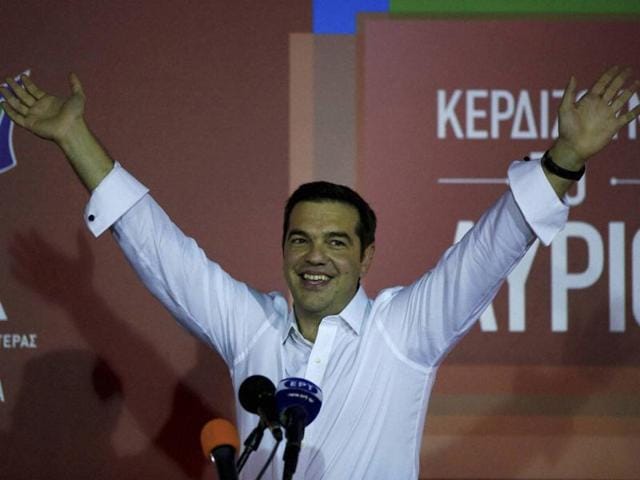 Left-wing Syriza party leader Alexis Tsipras waves to his supporters at Syriza's party’s main electoral center in Athens, on Sunday. Tsipras, who won Greece's parliamentary election for the second time this year, says he will form a coalition government with the small right-wing Independent Greeks.(AP Photo)
