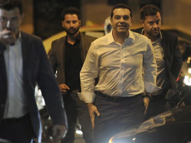 Leader of the left-wing Syriza party and former Prime Minister Alexis Tsipras, center, surrounded by his security arrives at the headquarters of his party in Athens, Sunday, Sept. 20, 2015. Tsipras appeared poised for victory in Greece’s early election Sunday, but falling short of an absolute majority needed to form a government. (AP) Leader of the left-wing Syriza party and former Prime Minister Alexis Tsipras, center, surrounded by his security arrives at the headquarters of his party in Athens, Sunday, Sept. 20, 2015. Tsipras appeared poised for victory in Greece’s early election Sunday, but falling short of an absolute majority needed to form a government. (AP)