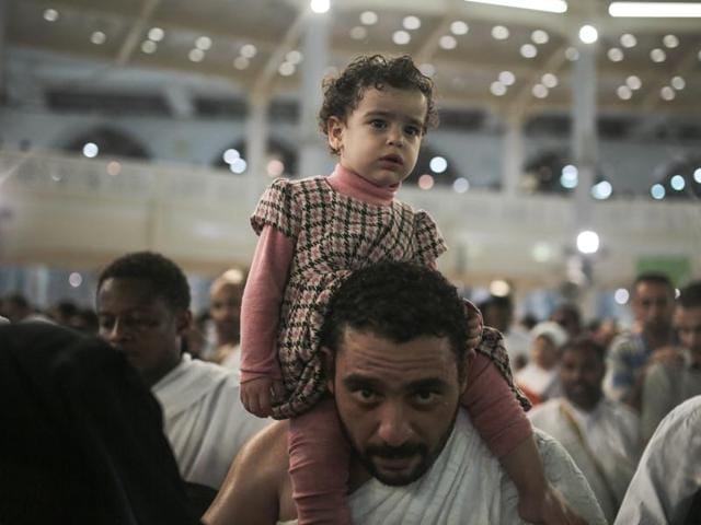 A Muslim pilgrim carries his daughter as they circle the Kaaba, the cubic building at the Grand Mosque in the Muslim holy city of Mecca, while performing Tawwaf, an anti-clockwise movement around the Kaaba and one of the main rites of the annual Pilgrimage, known as hajj, in Saudi Arabia. (AP) A Muslim pilgrim carries his daughter as they circle the Kaaba, the cubic building at the Grand Mosque in the Muslim holy city of Mecca, while performing Tawwaf, an anti-clockwise movement around the Kaaba and one of the main rites of the annual Pilgrimage, known as hajj, in Saudi Arabia. (AP)