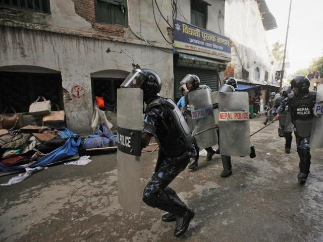 Nepalese policemen chase protesters after they burnt a copy of the new constitution during the protest organized by splinter of the Maoist party, alliance of ethnic group and Madhesi party, in Kathmandu. (AP) Nepalese policemen chase protesters after they burnt a copy of the new constitution during the protest organized by splinter of the Maoist party, alliance of ethnic group and Madhesi party, in Kathmandu. (AP)