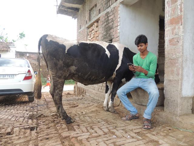 A boy uses mobile phone at Techa Bigha village. (ht photo) A boy uses mobile phone at Techa Bigha village. (ht photo)