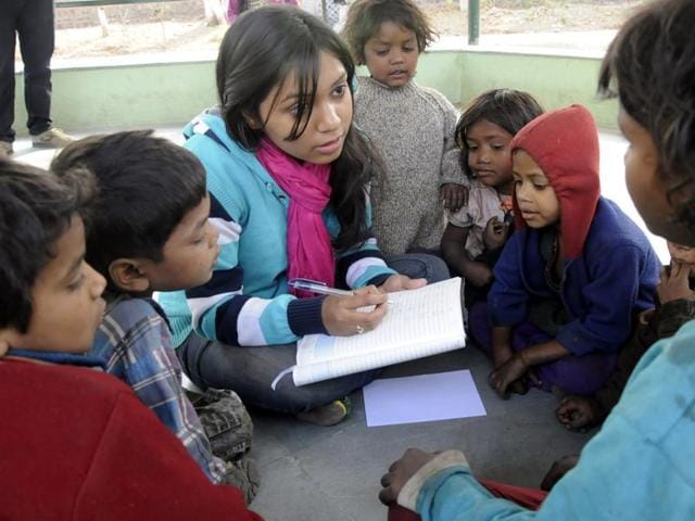 A social worker holds informal classes for out-of-school children at a poor settlement in Bhopal. (Mujeeb Faruqui/HT photo) A social worker holds informal classes for out-of-school children at a poor settlement in Bhopal. (Mujeeb Faruqui/HT photo)