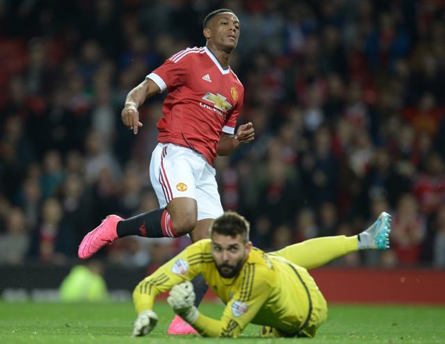 Manchester United's French midfielder Anthony Martial, left, scores the third goal past Ipswich Town's Polish goalkeeper Piotr Malarczyk during the League Cup third round match at Old Trafford, on September 23, 2015. (AFP Photo) Manchester United's French midfielder Anthony Martial, left, scores the third goal past Ipswich Town's Polish goalkeeper Piotr Malarczyk during the League Cup third round match at Old Trafford, on September 23, 2015. (AFP Photo)