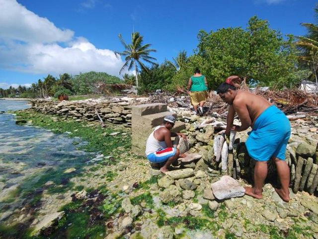 A file photograph released by the secretariat of the Pacific community (SPC) shows inhabitants of Kiritimati coral atoll building a stone seawall to struggle against sea level rise cause by global warming. (AFP File) A file photograph released by the secretariat of the Pacific community (SPC) shows inhabitants of Kiritimati coral atoll building a stone seawall to struggle against sea level rise cause by global warming. (AFP File)