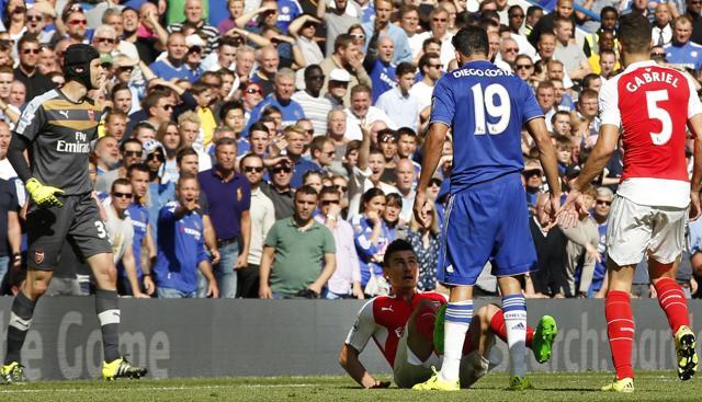 Chelsea's Diego Costa, No 19, stands over Arsenal's Laurent Koscielny as Arsenal's Gabriel Paulista, right, looks on during the EPL match at Stamford Bridge, London, on September 19, 2015. (AP Photo) Chelsea's Diego Costa, No 19, stands over Arsenal's Laurent Koscielny as Arsenal's Gabriel Paulista, right, looks on during the EPL match at Stamford Bridge, London, on September 19, 2015. (AP Photo)