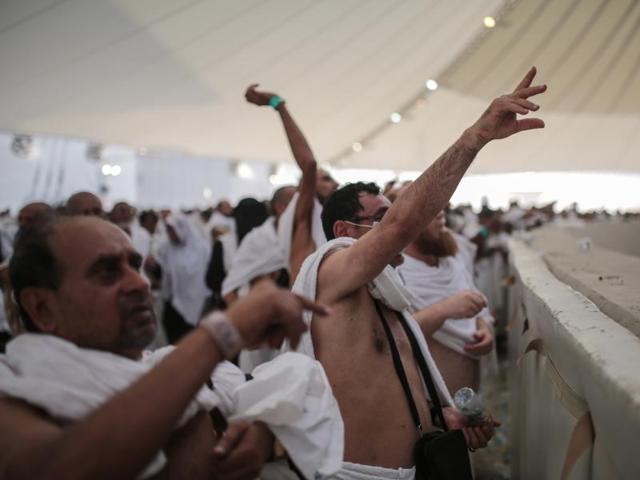 Muslim pilgrims cast stones at the pillar symbolizing the stoning of Satan in a “Jamarat” ritual during the annual haj on the first day of Eid al-Adha. During this ritual, over 700 people were killed in a stampede. (AP)