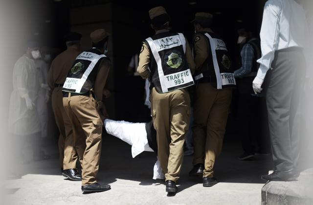 Saudi policemen carry an injured pilgrim outside an emergency hospital following a deadly stampede in Mina, near the holy city of Mecca (AFP) Saudi policemen carry an injured pilgrim outside an emergency hospital following a deadly stampede in Mina, near the holy city of Mecca (AFP)