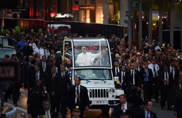 Pope Francis waves as he approaches the St Patrick's Cathedral to lead evening prayers in New York on September 24, 2015. Pope Francis arrived in New York on the second leg of his US tour where he will address the UN General Assembly, visit the 9/11 Memorial and celebrate mass at Madison Square Garden. (AFP Photo) Pope Francis waves as he approaches the St Patrick's Cathedral to lead evening prayers in New York on September 24, 2015. Pope Francis arrived in New York on the second leg of his US tour where he will address the UN General Assembly, visit the 9/11 Memorial and celebrate mass at Madison Square Garden. (AFP Photo)