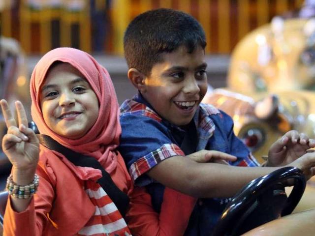 Iraqi children play on bumper cars at an amusment park in the southern city of Basra. (aFP Photo)