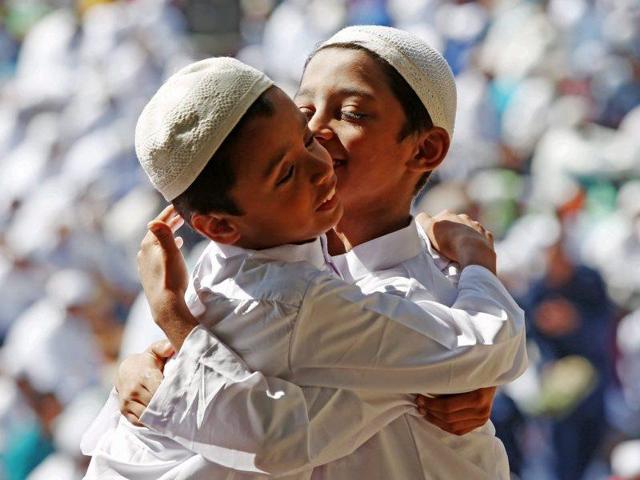 Indian Muslims boys hug each other after their morning prayers on the occasion of Eid al-Adha in Bangalore, India. (ePA)