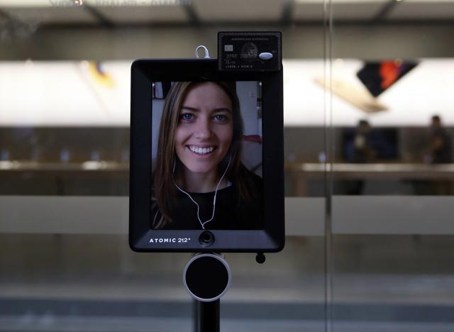 Lucy Kelly is seen on a screen attached to a 'telepresence robot', which she used to purchase her iPhone 6s during the official launch at the Apple store in Sydney, Australia. (REUTERS) Lucy Kelly is seen on a screen attached to a 'telepresence robot', which she used to purchase her iPhone 6s during the official launch at the Apple store in Sydney, Australia. (REUTERS)