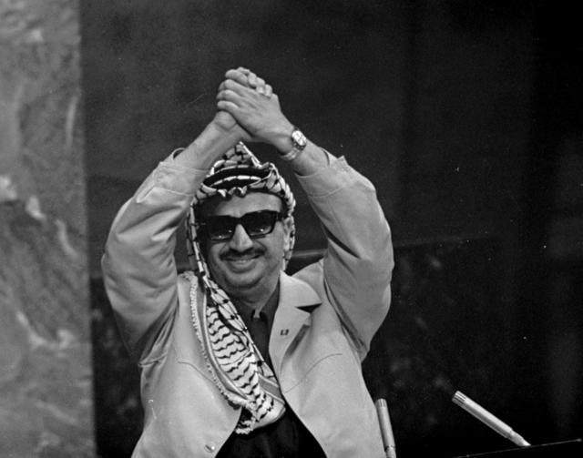 Palestine Liberation Organization leader Yasser Arafat clasps his arms over his head as he addresses the United Nations General Assembly. (AP) Palestine Liberation Organization leader Yasser Arafat clasps his arms over his head as he addresses the United Nations General Assembly. (AP)