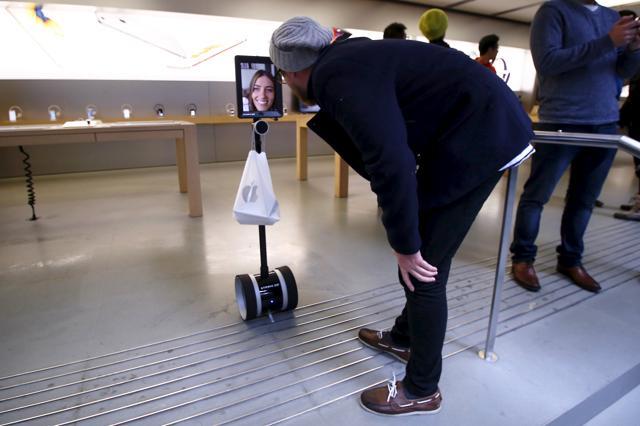 A man talks to Lucy Kelly on a screen attached to the robot. (REUTERS) A man talks to Lucy Kelly on a screen attached to the robot. (REUTERS)