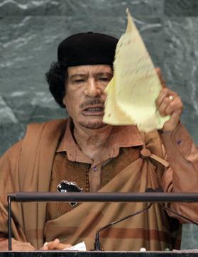 Libyan leader Moammar Gadhafi, dressed in flowing brown Bedouin robes, waves a copy of the UN Charter after appearing to tear it, saying he did not recognize the document's authority, as he addresses the 64th session of the United Nations General Assembly. (AP) Libyan leader Moammar Gadhafi, dressed in flowing brown Bedouin robes, waves a copy of the UN Charter after appearing to tear it, saying he did not recognize the document's authority, as he addresses the 64th session of the United Nations General Assembly. (AP)