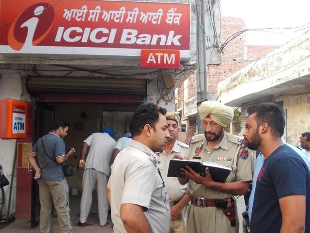 Police investigating the spot from where an ATM machine was uprooted by miscreants on Wednesday. (HT Photo) Police investigating the spot from where an ATM machine was uprooted by miscreants on Wednesday. (HT Photo)