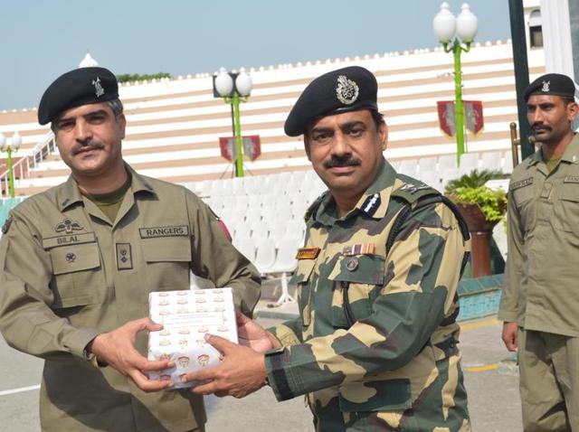 BSF deputy inspector general MF Farooqui (R) exchanging sweets with Pakistan Rangers wing commander Bilal (L) on the occasion of Eid-ul-Adha at Attari Border near Amritsar on Friday. (HT Photo) BSF deputy inspector general MF Farooqui (R) exchanging sweets with Pakistan Rangers wing commander Bilal (L) on the occasion of Eid-ul-Adha at Attari Border near Amritsar on Friday. (HT Photo)