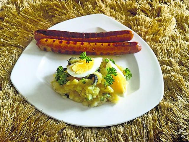 Grilled sausages served with roast potato Grilled sausages served with roast potato