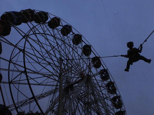 A boy does bungee jumping at the Mount Mary fair at Bandra in Mumbai. (Pratham Gokhale/HT photo)