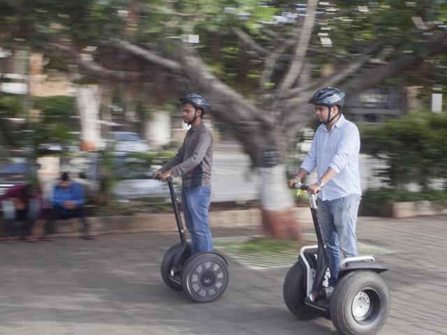 People ride segway at Nariman Point in Mumbai as part of a joy ride organised by Maharashtra Tourism Development Corporation. (Kunal Patil/HT photo)