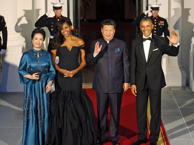 President Barack Obama, right, and Chinese President Xi Jinping, second from right, wave along with, wives Peng Liyuan, left, and first lady Michelle Obama as they arrive for a state dinner at the White House in Washington. (AP Photo) President Barack Obama, right, and Chinese President Xi Jinping, second from right, wave along with, wives Peng Liyuan, left, and first lady Michelle Obama as they arrive for a state dinner at the White House in Washington. (AP Photo)