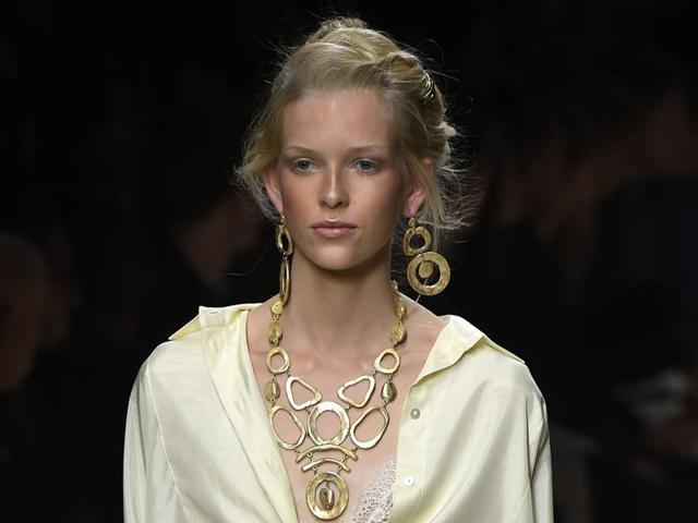 An elaborate up-do softened by strands of hair falling around the face invoked the desert at Alberta Ferretti, supported by sandy-toned bronzer and a dusky pink lip. (AFP)