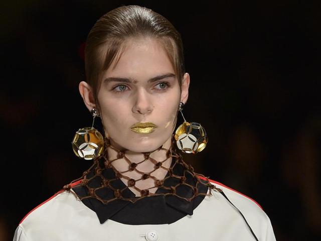 Prada had fun experimenting with an opaque gold lip and a hairstyle that looked a lot like sideburns. (AFP)