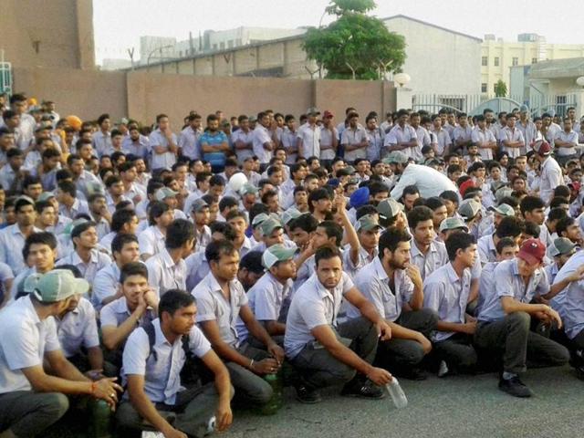 Maruti Suzuki's temporary workers protest in lieu of their demands at the company's Manesar Plant near Girgaon on Saturday. (PTI)