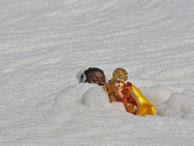 A devotee carries a statue of Ganesh to be immersed into the polluted waters of the river Yamuna on the last day of the Ganesh Chaturthi festival, in New Delhi. (Reuters Photo) A devotee carries a statue of Ganesh to be immersed into the polluted waters of the river Yamuna on the last day of the Ganesh Chaturthi festival, in New Delhi. (Reuters Photo)