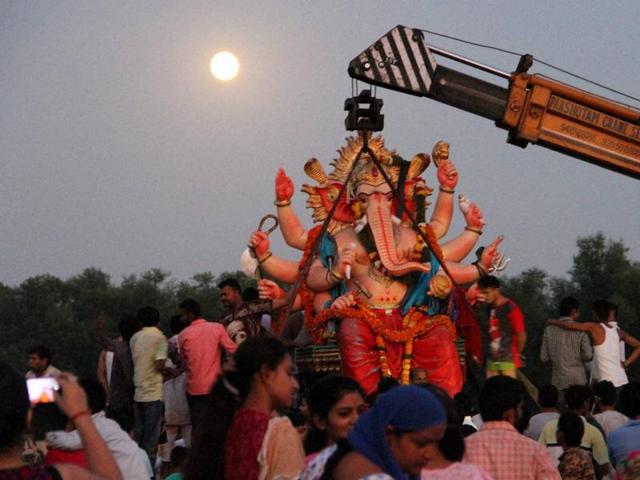 Devotees immerse an idol of Lord Ganesh during Ganesh Chaturthi celebrations at Akhnoor near Jammu on Sunday. (PTI Photo) Devotees immerse an idol of Lord Ganesh during Ganesh Chaturthi celebrations at Akhnoor near Jammu on Sunday. (PTI Photo)