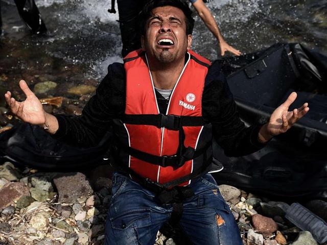 A man reacts as he arrives with other refugees and migrants to the Greek island of Lesbos after crossing the Aegean sea from Turkey. (AFP Photo) A man reacts as he arrives with other refugees and migrants to the Greek island of Lesbos after crossing the Aegean sea from Turkey. (AFP Photo)