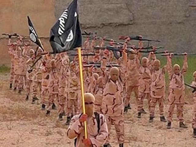 In this photo released by a militant website, young boys known as the "lion cubs" hold rifles and Islamic State group flags as they exercise at a training camp in Tal Afar, near Mosul, northern Iraq. (Militant website via AP Photo) In this photo released by a militant website, young boys known as the "lion cubs" hold rifles and Islamic State group flags as they exercise at a training camp in Tal Afar, near Mosul, northern Iraq. (Militant website via AP Photo)